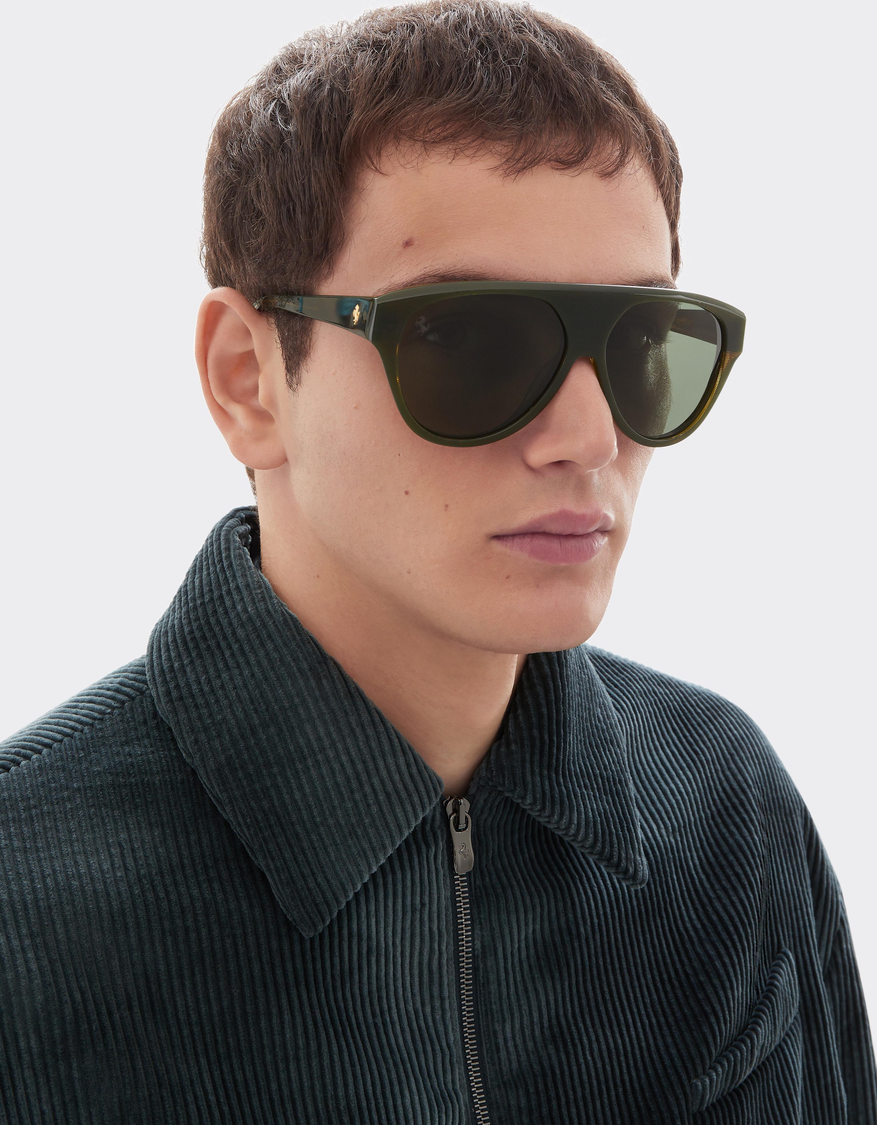 Sunglasses in striped green acetate with green polarised lenses