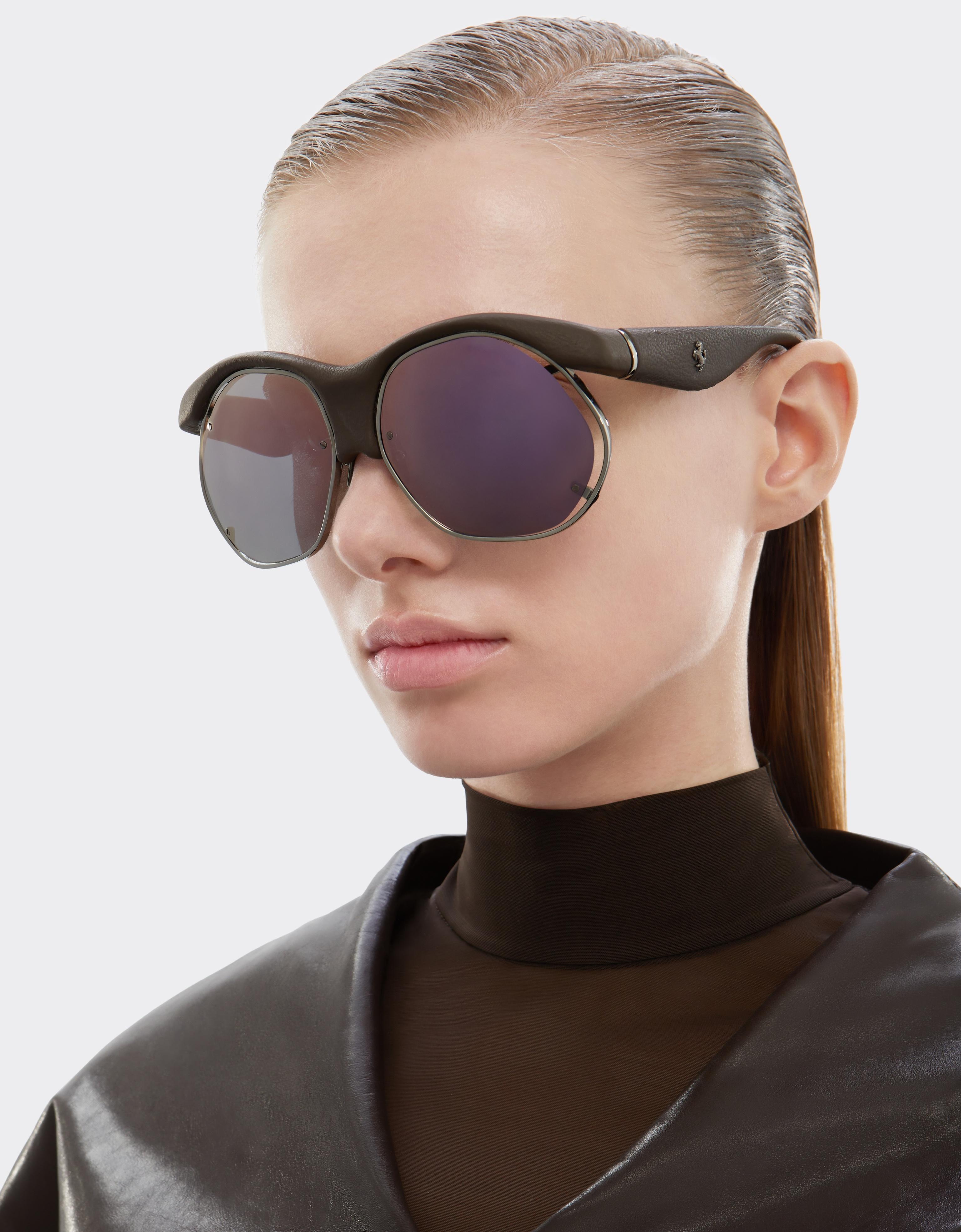 Injection-moulded sunglasses in metal and dark brown leather with grey lenses featuring a pink mirror finish