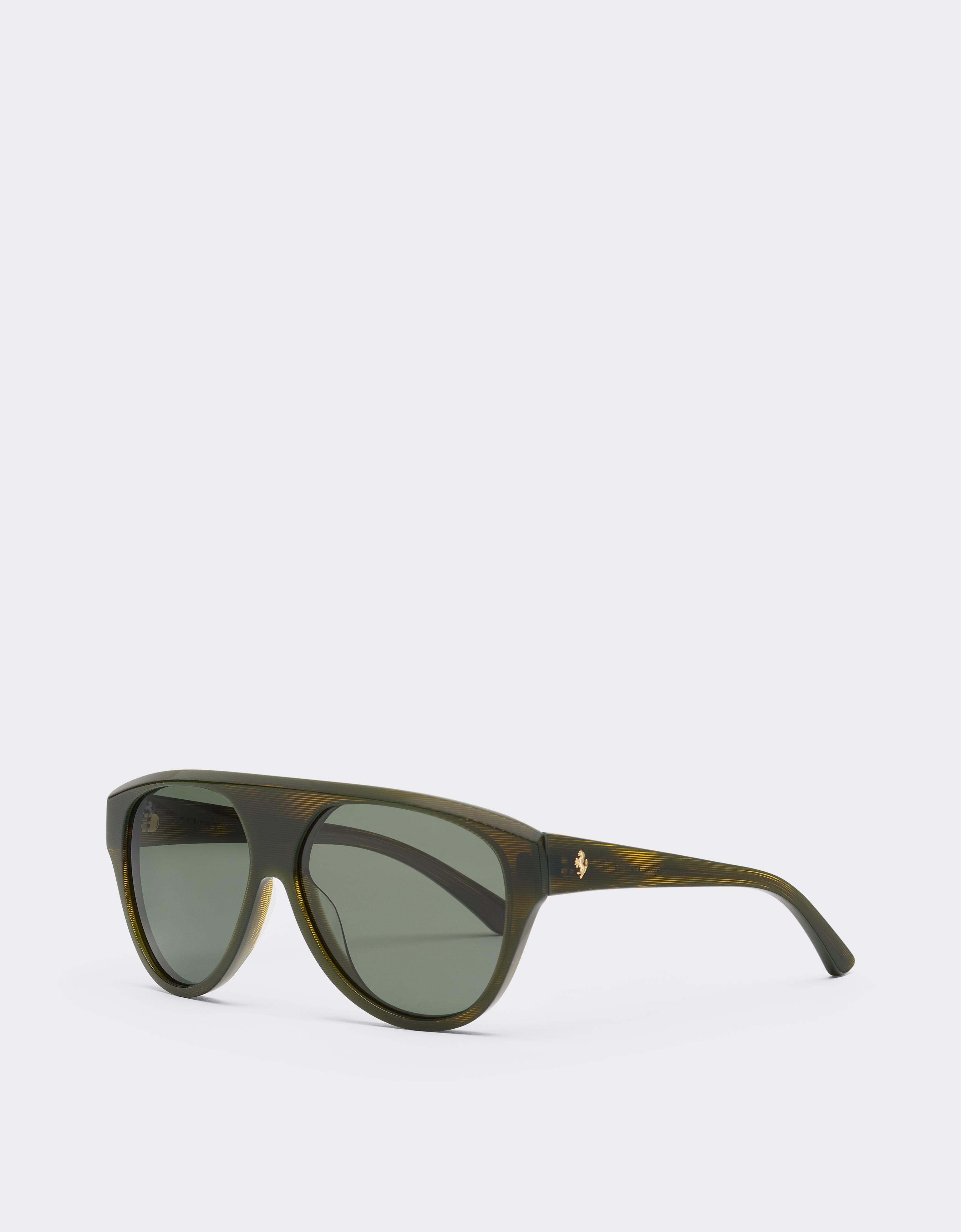 Sunglasses in striped green acetate with green polarised lenses