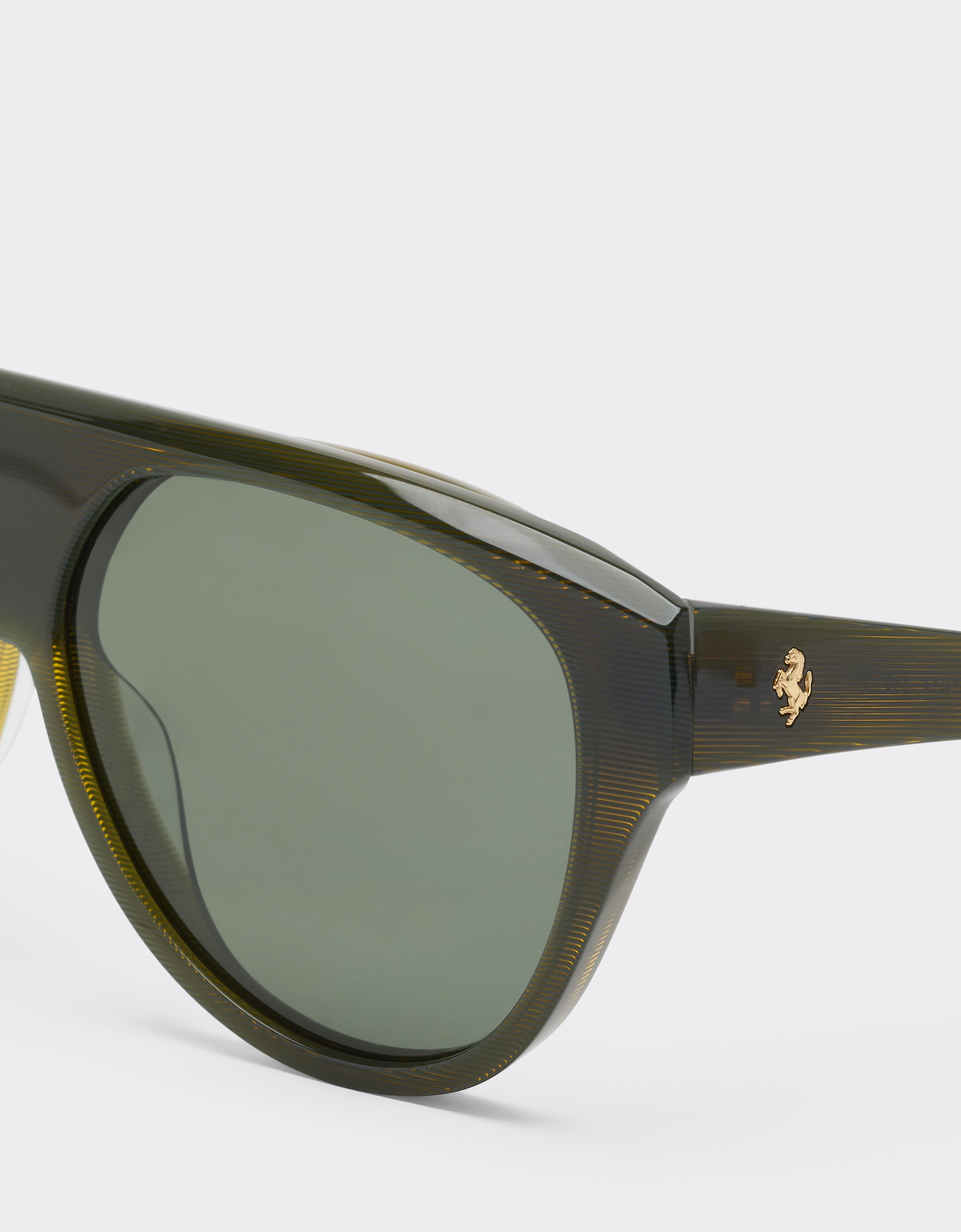 Sunglasses in striped green acetate with green polarised lenses